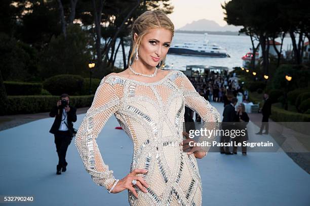 Socialite Paris Hilton poses for photographs at the amfAR's 23rd Cinema Against AIDS Gala at Hotel du Cap-Eden-Roc on May 19, 2016 in Cap d'Antibes,...