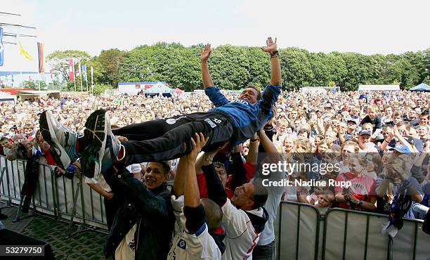 Coach Thomas Doll is carried by HSV-Fans during the Hamburger SV training session and Fans Day on July 24, 2005 in Hamburg, Germany.