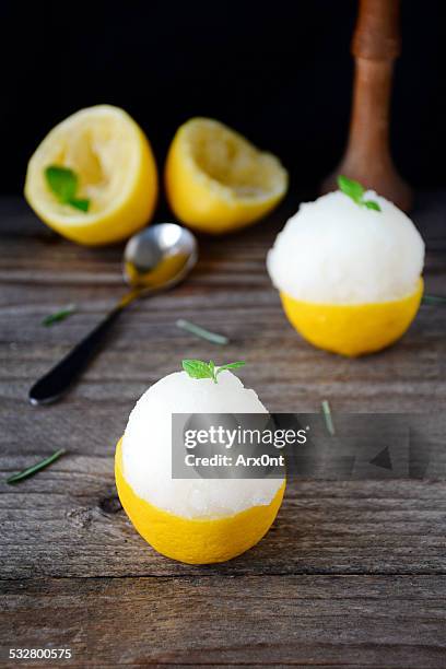 lemon sorbet served in frosted lemon halves - sorbet stock pictures, royalty-free photos & images