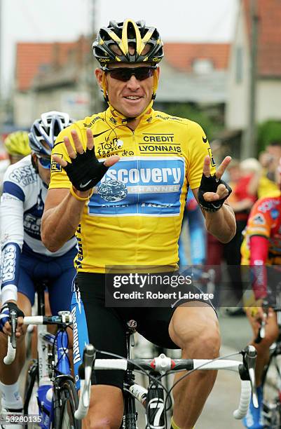 Lance Armstrong of the USA riding for the Discovery Channel team holds up 7 fingers which represents him winning a seventh consecutive Tour de France...