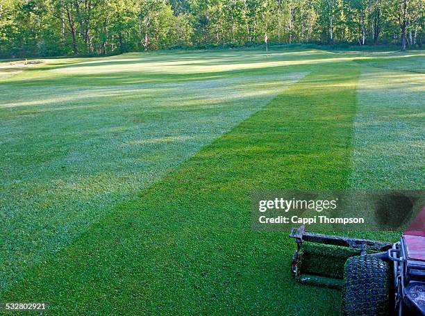 mowing the golf course - golf course maintenance stock pictures, royalty-free photos & images