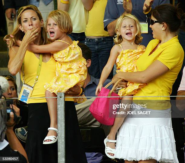 Lance Armstrong's girlfriend US pop singer Sheryl Crow, his two daughters and an unidentified nanny cheer in the stands on the Champs Elysees the...