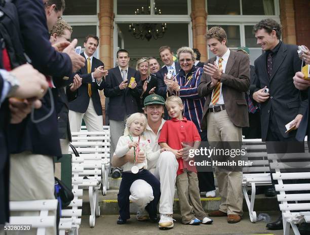 Glenn McGrath of Australia, with children Holly and James, is applauded by the members during day four of the First Test between England and...