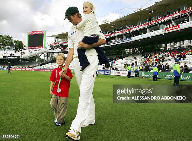 London, UNITED KINGDOM: Australian bowler Glenn McGrath takes his children Holly and James to the Pavilion after Australia beat England in the first...