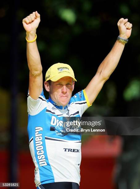 Lance Armstrong of the USA, riding for the Discovery Channel, acknowledges the crowd from the podium after winning a seventh consecutive Tour de...