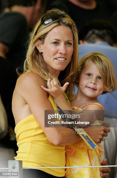 Singer Sheryl Crow and one of Lance Armstrong's twin daughters, Grace, cheer him on during Stage 21 of the Tour de France between Montereau and The...