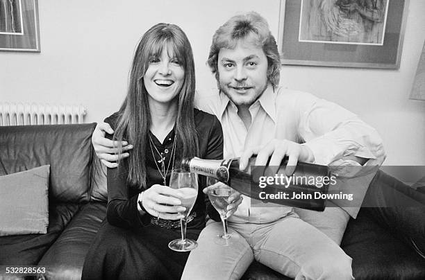 Welsh film and television actor Hywel Bennett shares a bottle of champagne with his bride-to-be British broadcaster and journalist Cathy McGowan,...