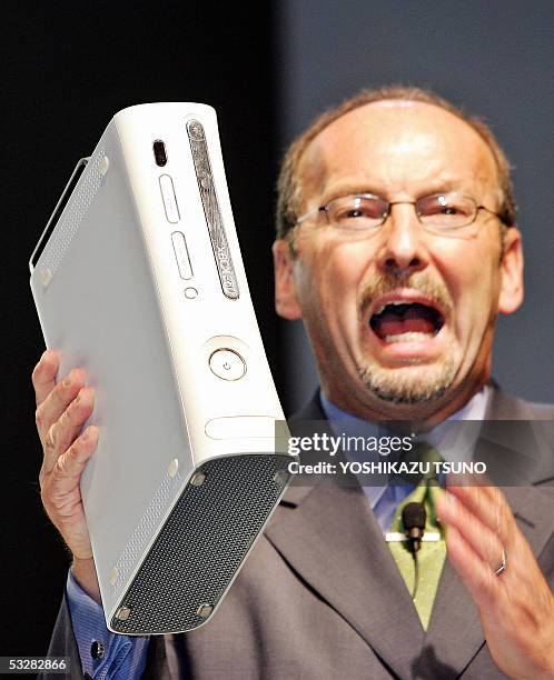 Software giant Microsoft Vice President Peter Moore displays the company's next generation video game console 'Xbox 360', equipped with IBM's PowerPC...