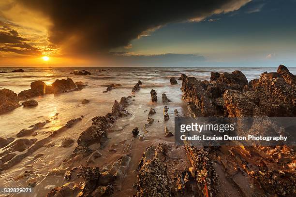 sunset over the rocks at mindil beach - darwin stock pictures, royalty-free photos & images
