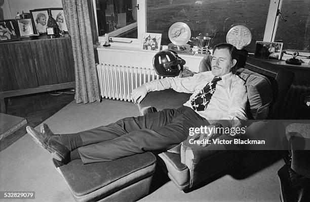 British racing driver and team owner Graham Hill relaxing at home, 5th January 1972.