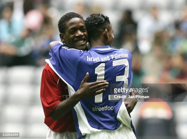 Unidentified players hug during the friendly match between the under 17 Team of Bayern Munich and the Israeli and Palestinian Peres Center "Peace...