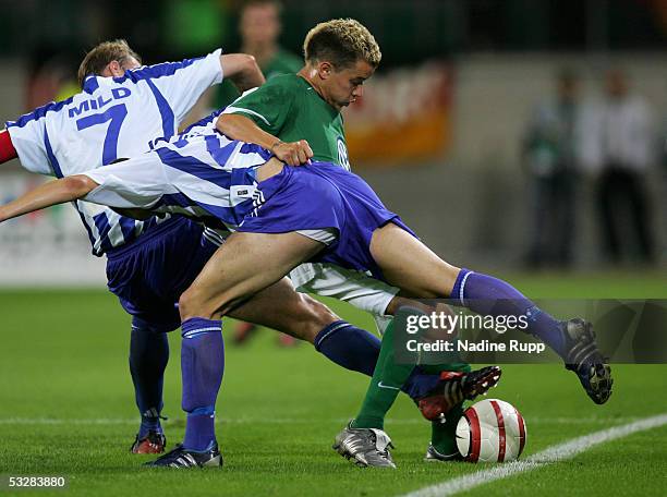 Hakan Mild and Jonatan Berg of Goteborg compete with Andres D'Alessandro of Wolfsburg during the UEFA Intertoto Cup third round match between VFL...