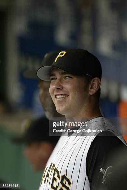 Pitcher Zach Duke of the Pittsburgh Pirates smiles while talking to teammates in the dugout prior to a game against the Colorado Rockies at PNC Park...