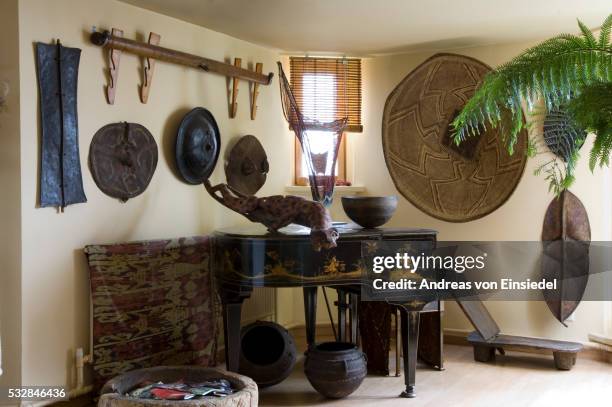 london penthouse furnished with african artefacts - wall hanging stock pictures, royalty-free photos & images