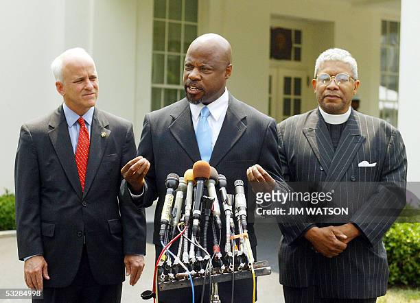 Washington, UNITED STATES: President of US Dream Academy ,Reverend Whitley Phipps gestures as he speaks while co-founder of the Ten Point Coalition...