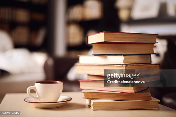 stack of books in home interior - boek stockfoto's en -beelden