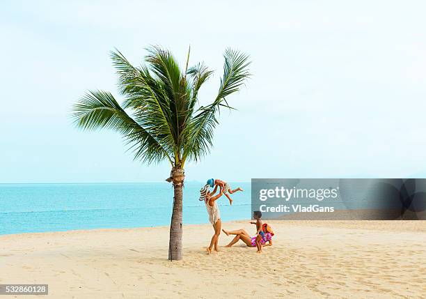 mother with baby at tropical beach - child palm of hand stock pictures, royalty-free photos & images