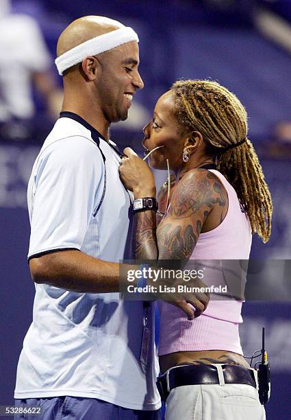 James Blake has his microphone fixed by Debra Wilson during Gibson/Baldwin "Night At The Net" charity event in Strauss Stadium at the Los Angeles...