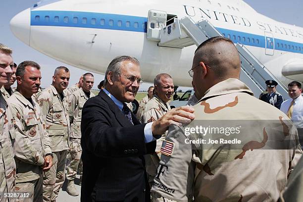 Secretary of Defense Donald Rumsfeld meets with U.S. Air force personnel as he prepares to depart July 26, 2005 from Manas Airport in Bishkek,...