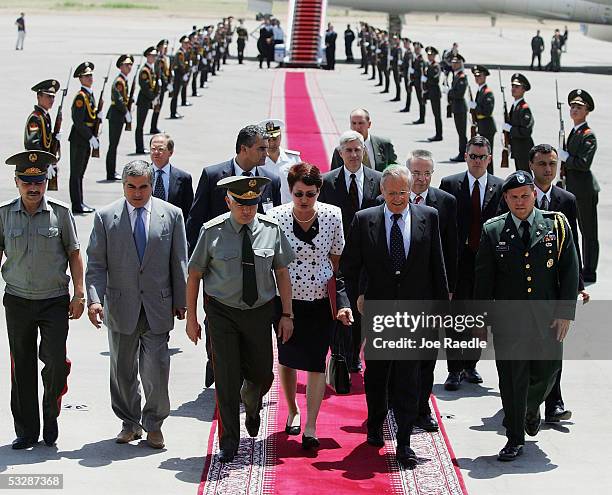 Secretary of Defense Donald Rumsfeld walks with Tajikistan Minister of Defense Colonel General Sherali Khairulloyev as he arrives July 26, 2005 in...