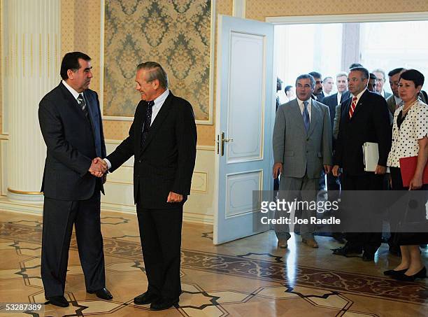 Secretary of Defense Donald Rumsfeld shakes hands with Tajikistan President Emomali Sharipovich Rahmonov as he arrives July 26, 2005 in Dushanbe,...