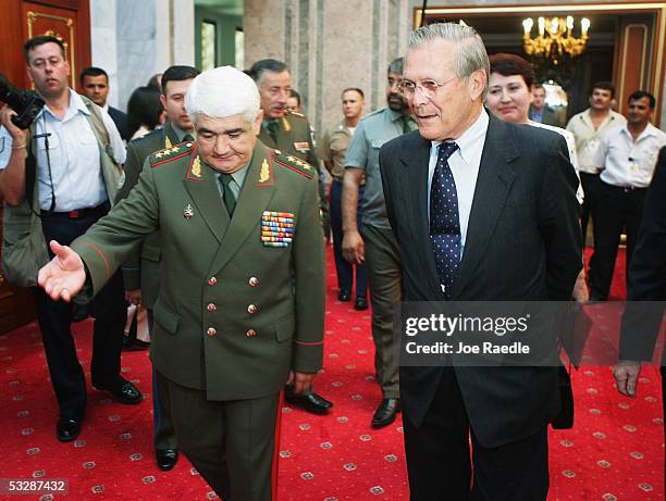 Secretary of Defense Donald Rumsfeld is escorted to a meeting by Tajikistan Minister of Defense Colonel General Sherali Khairulloyev as he arrives...