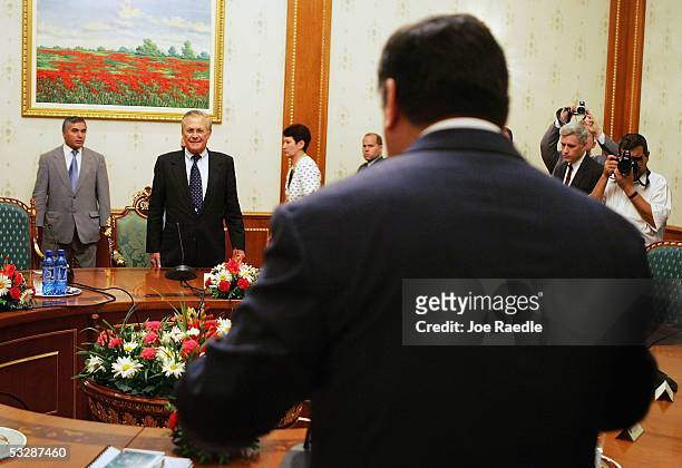 Secretary of Defense Donald Rumsfeld prepares to sit with Tajikistan President Emomali Sharipovich Rahmonov for a meeting July 26, 2005 in Dushanbe,...