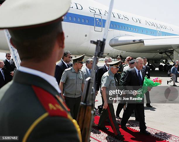 Secretary of Defense Donald Rumsfeld walks with Tajikistan Minister of Defense Colonel General Sherali Khairulloyev as he arrives July 26, 2005 in...