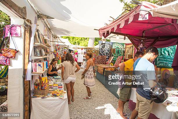 Hippie market in the island of Ibiza with people and sunny day in summer time. Balearic Islands, Europe.