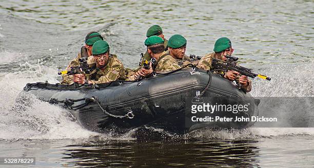 British Royal Marine Commandos the put on a display of military culture on the River Trent in Nottinghamshire on the National Armed Forces Day in...