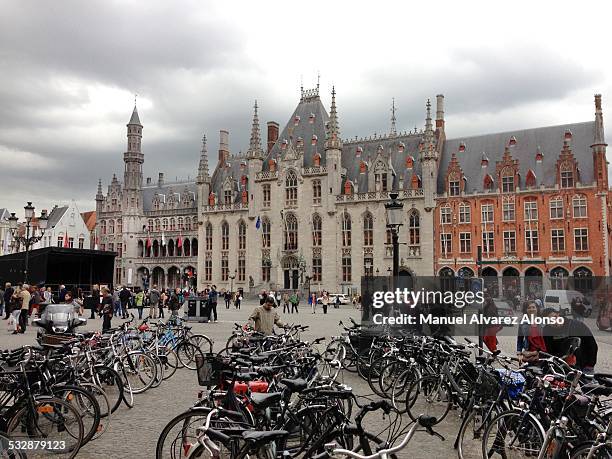 Rife a bike, the New Year resolution is to take over the bike to get to know the Grote Markt in Bruges, Belgium, Europe