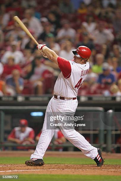 Outfielder Adam Dunn of the Cincinnati Reds follows through on his swing against the Colorado Rockies during the MLB game on July 16, 2005 at Great...