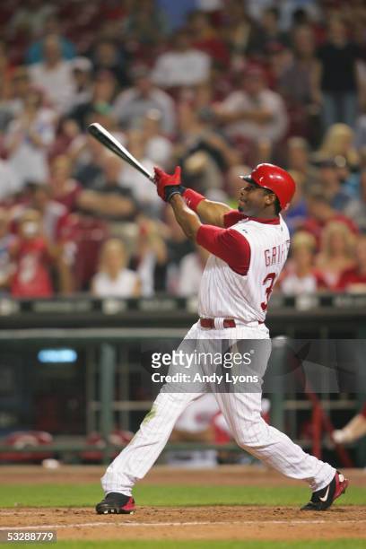 Outfielder Ken Griffey Jr. #30 of the Cincinnati Reds follows through on a swing against the Colorado Rockies during the MLB game on July 16, 2005 at...