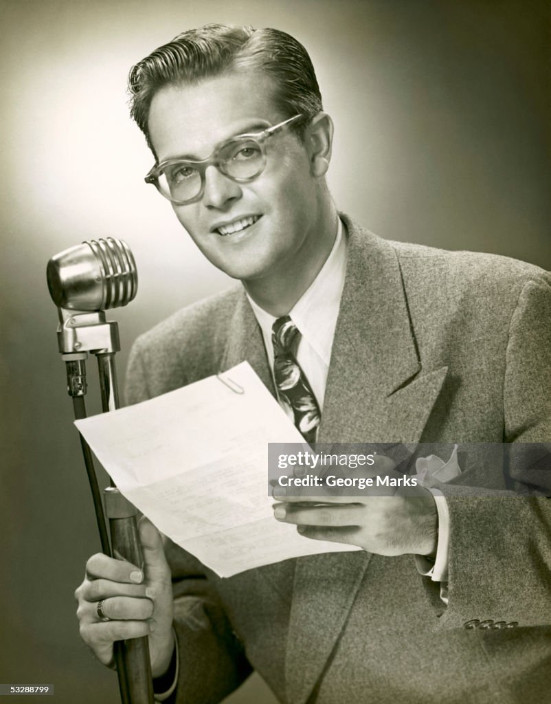 Man standing behind microphone