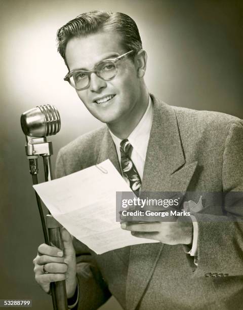 man standing behind microphone - radio dj stock pictures, royalty-free photos & images