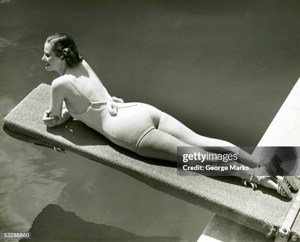 woman laying on diving board - woman diving board stock pictures, royalty-free photos & images