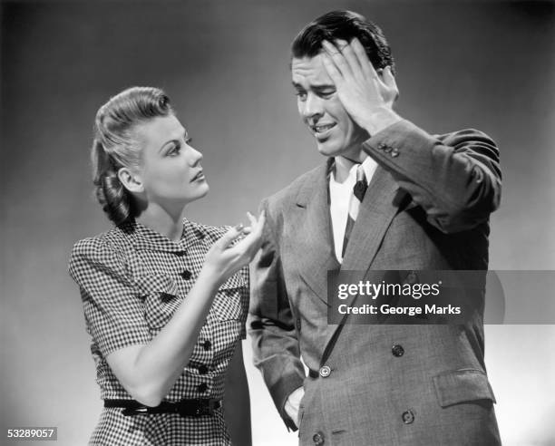 woman trying to console troubled man - 1950s couple stock pictures, royalty-free photos & images