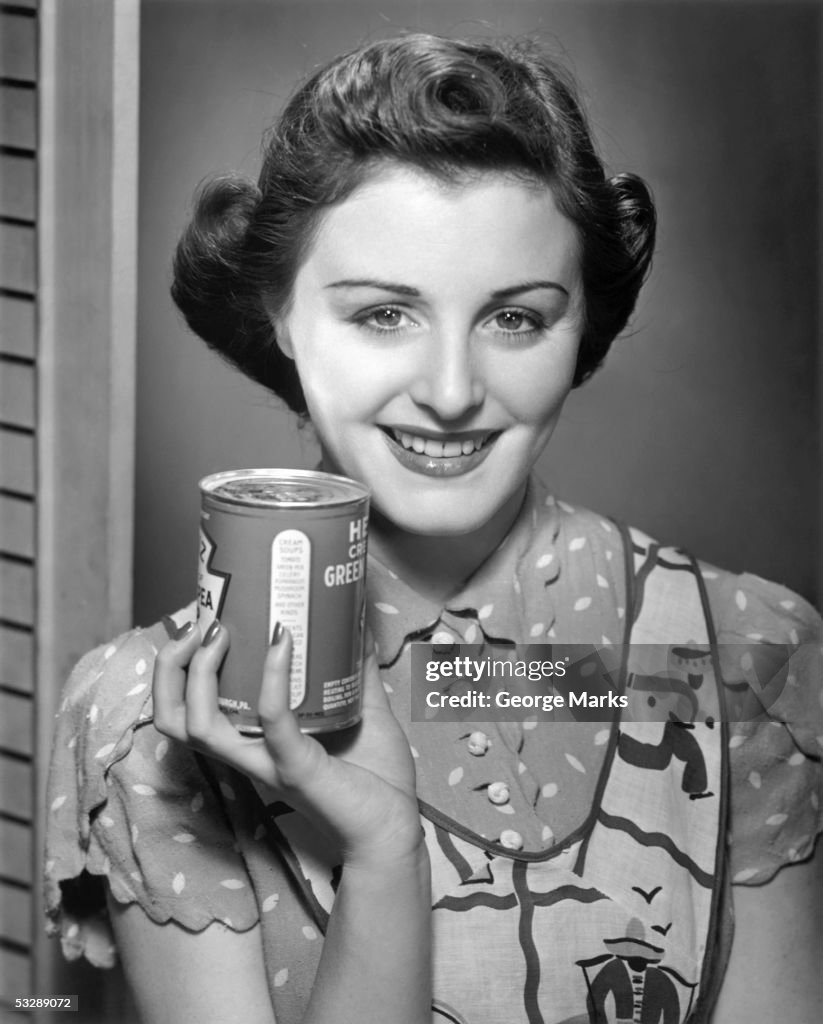 Woman holding a can of beans
