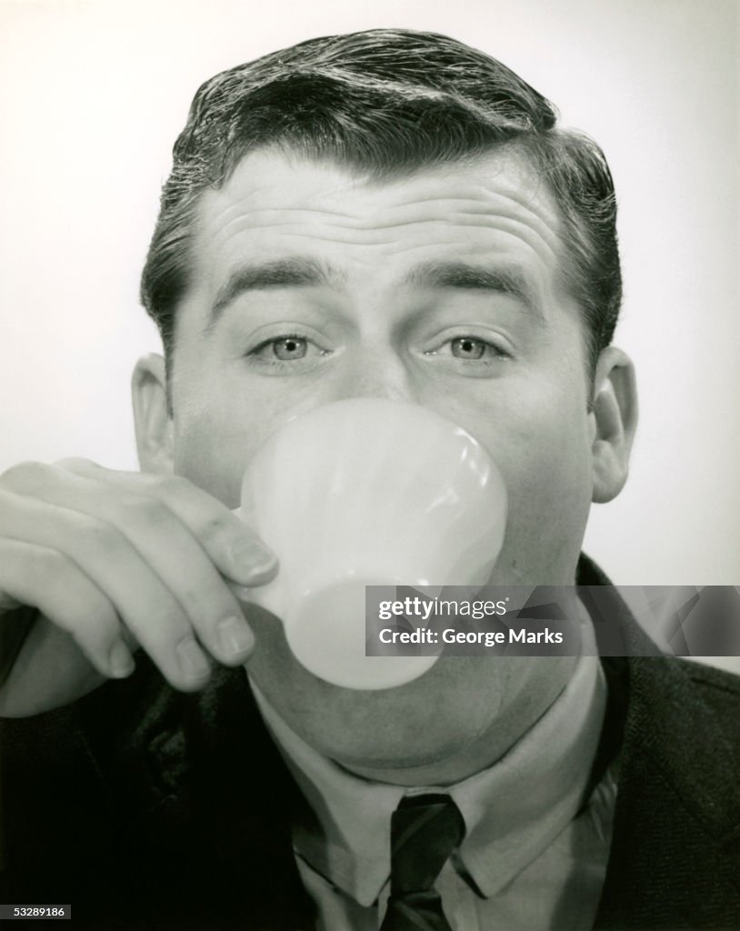 Man drinking from tea cup