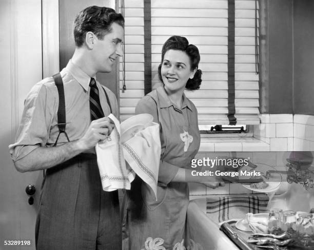 man and woman washing dishes - women in suspenders fotografías e imágenes de stock