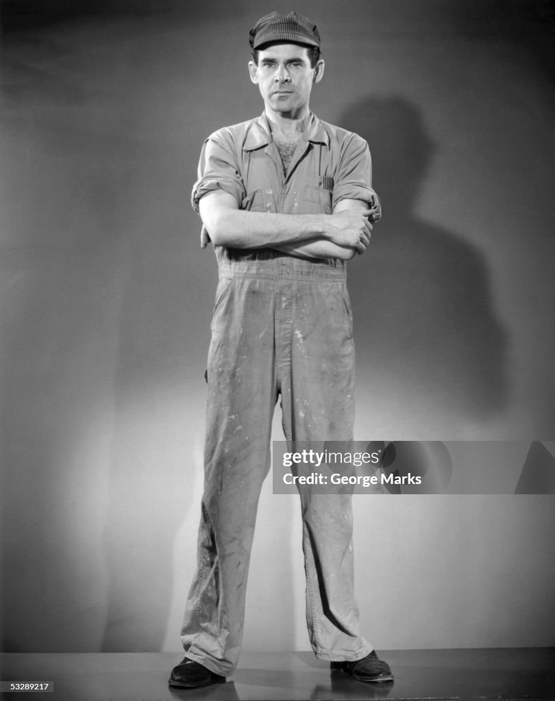 Low angle view of worker with arms cross