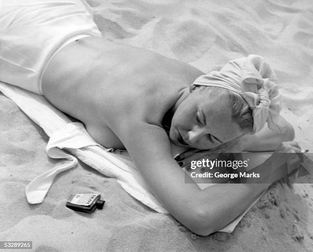 woman lying on beach topless - woman cigarette stock pictures, royalty-free photos & images