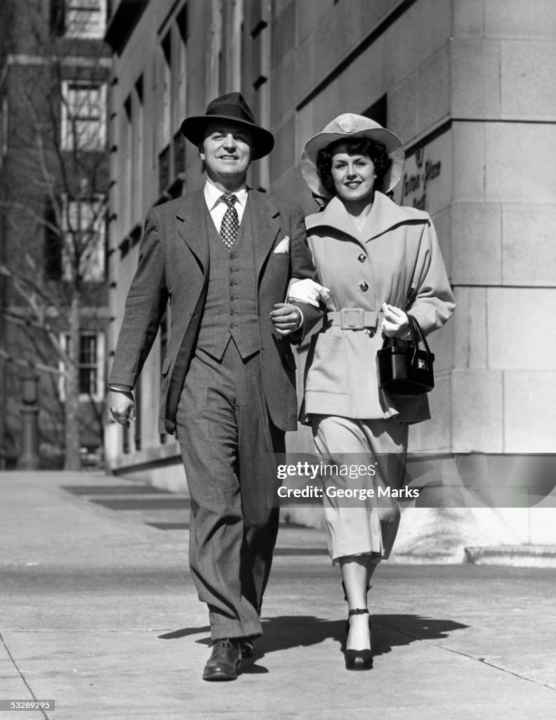 Man and woman walking down street