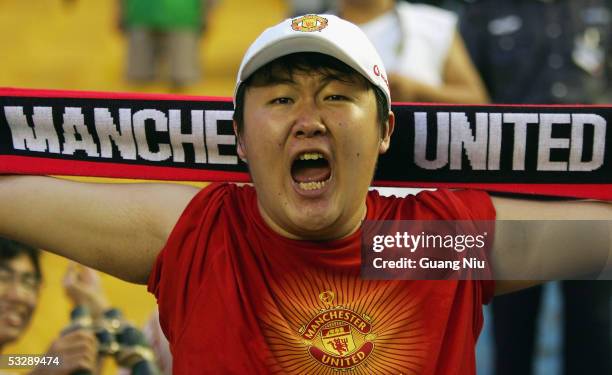 Chinese soccer fans watches the exhibition match between Manchester United and Beijing Hyundai FC at the Workers' Stadium.on July 26, 2005 in...