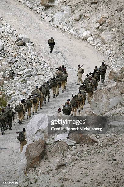 Pakistani Army soldiers march back to their barracks after training exercises at 13,800 feet June 17, 2005 in Gyari, Pakistan. Since 1982-84, the...