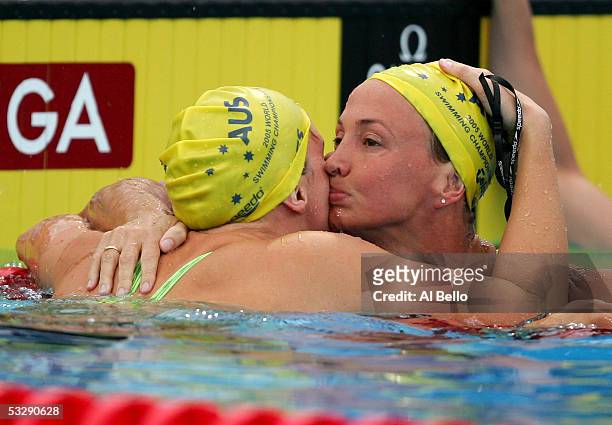 Brooke Hanson of Australia hugs teammate and gold medal winner Leisel Jones of Australia after their swim in the 100 meter Breaststroke final during...