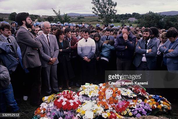 Sinn Fein leader Gerry Adams addresses the crowd in the funeral of an IRA volunteer, as officers of the Garda look on, Buncrana, County Donegal,...