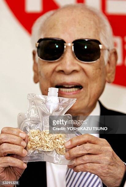 Momofuku Ando, Nissin food products chairman and popularly known as maker of instant noodles displays the instant noodles for astronauts called...