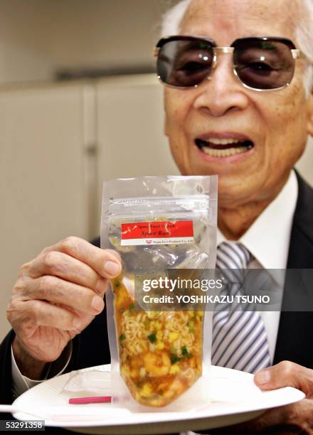 Momofuku Ando, Nissin food products chairman and popularly known as maker of instant noodles displays the instant noodles for astronauts called...