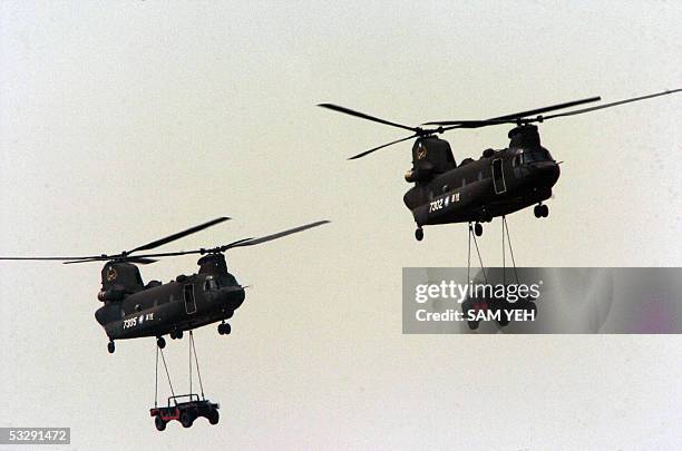 Two US-made CH-47 helicopters of the Taiwanese air force tranport military jeeps during the military exercise at CCK airforce base in Taichung,...